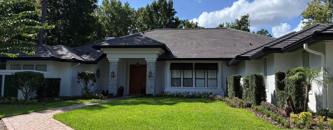 Single-story Florida home with a dark tile roof and landscaped front yard