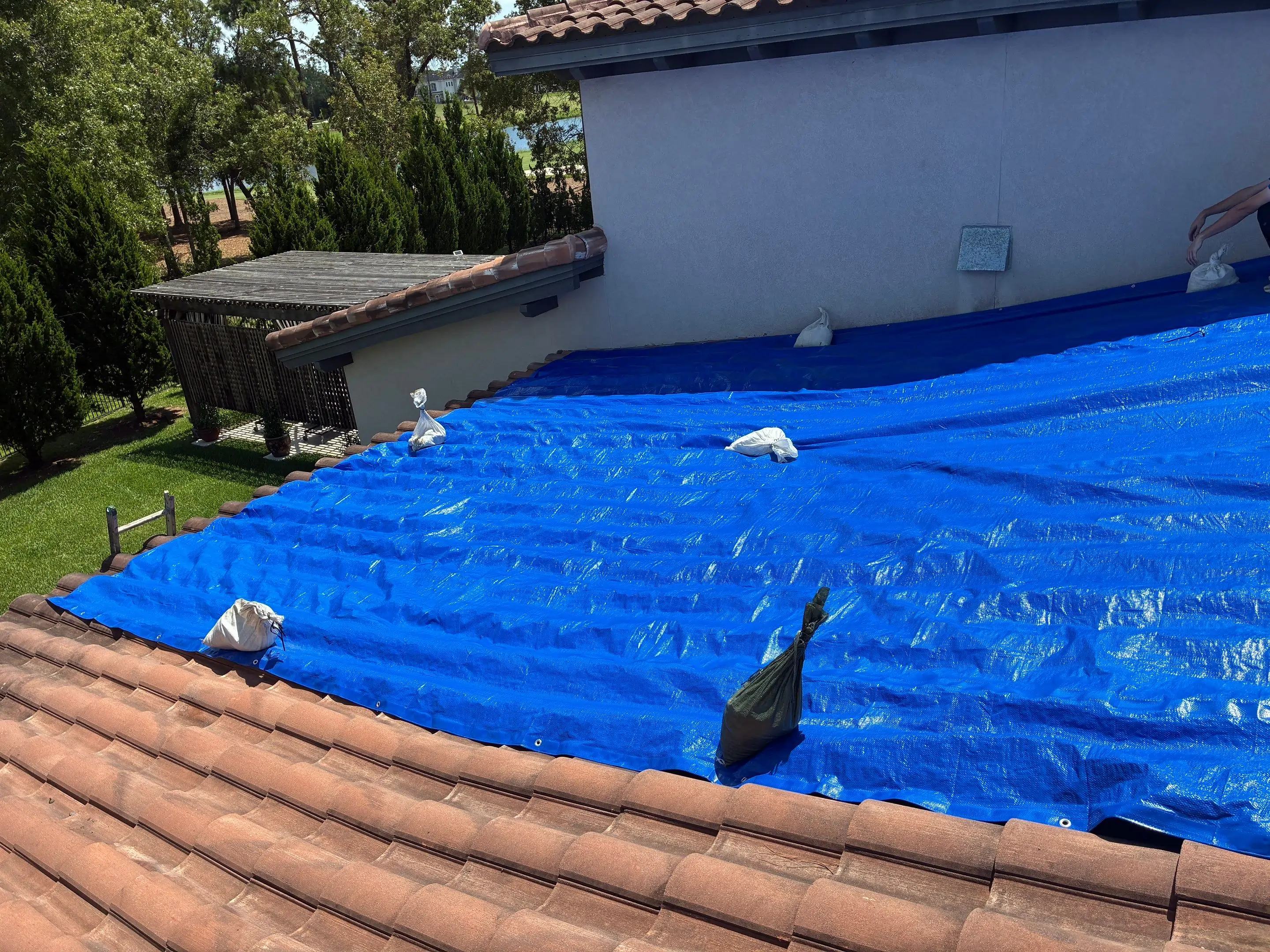 Metal roofing crew installing a standing seam roof on a large residential home in Florida.